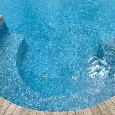 The pool has a Jacuzzi section right outside the front door