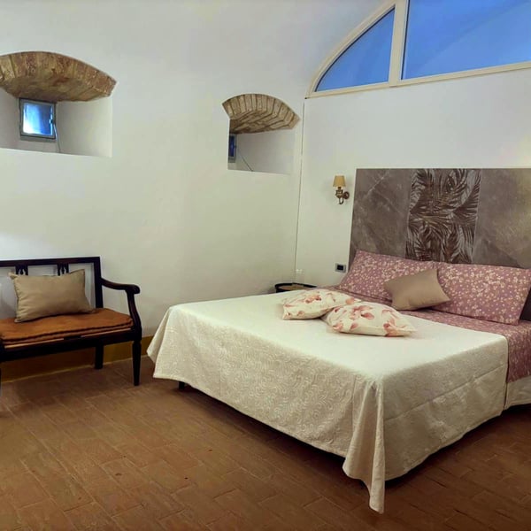 The double bedroom is lit by three medieval arrow slits