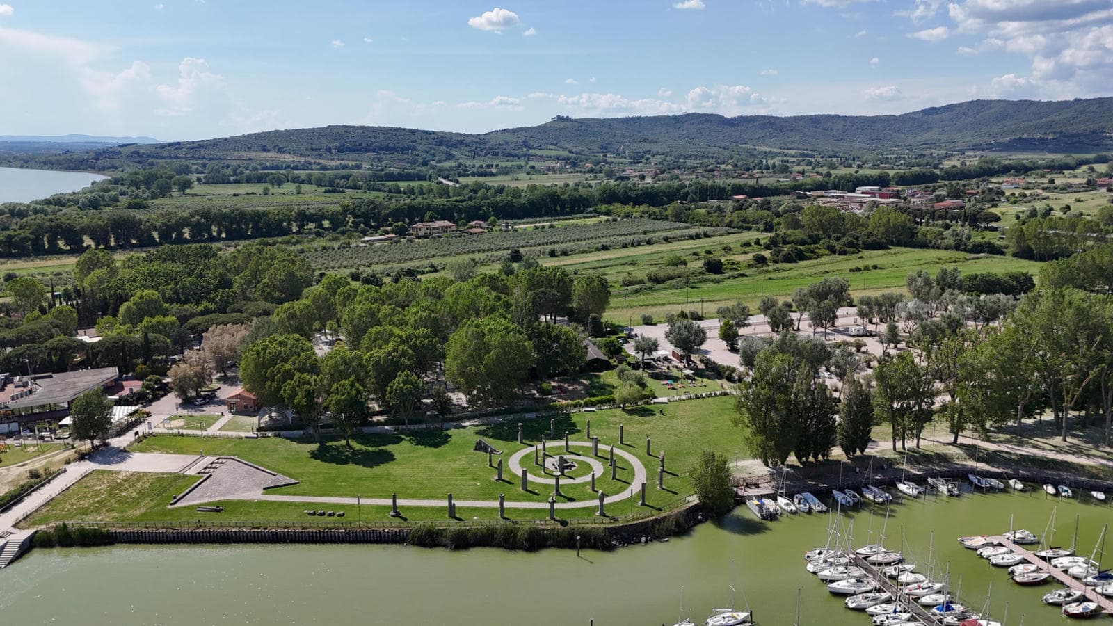 The ferry port at Tuoro has cafes, a small sailing harbour and a striking spiral sculpture. lago-trasimeno-aerial